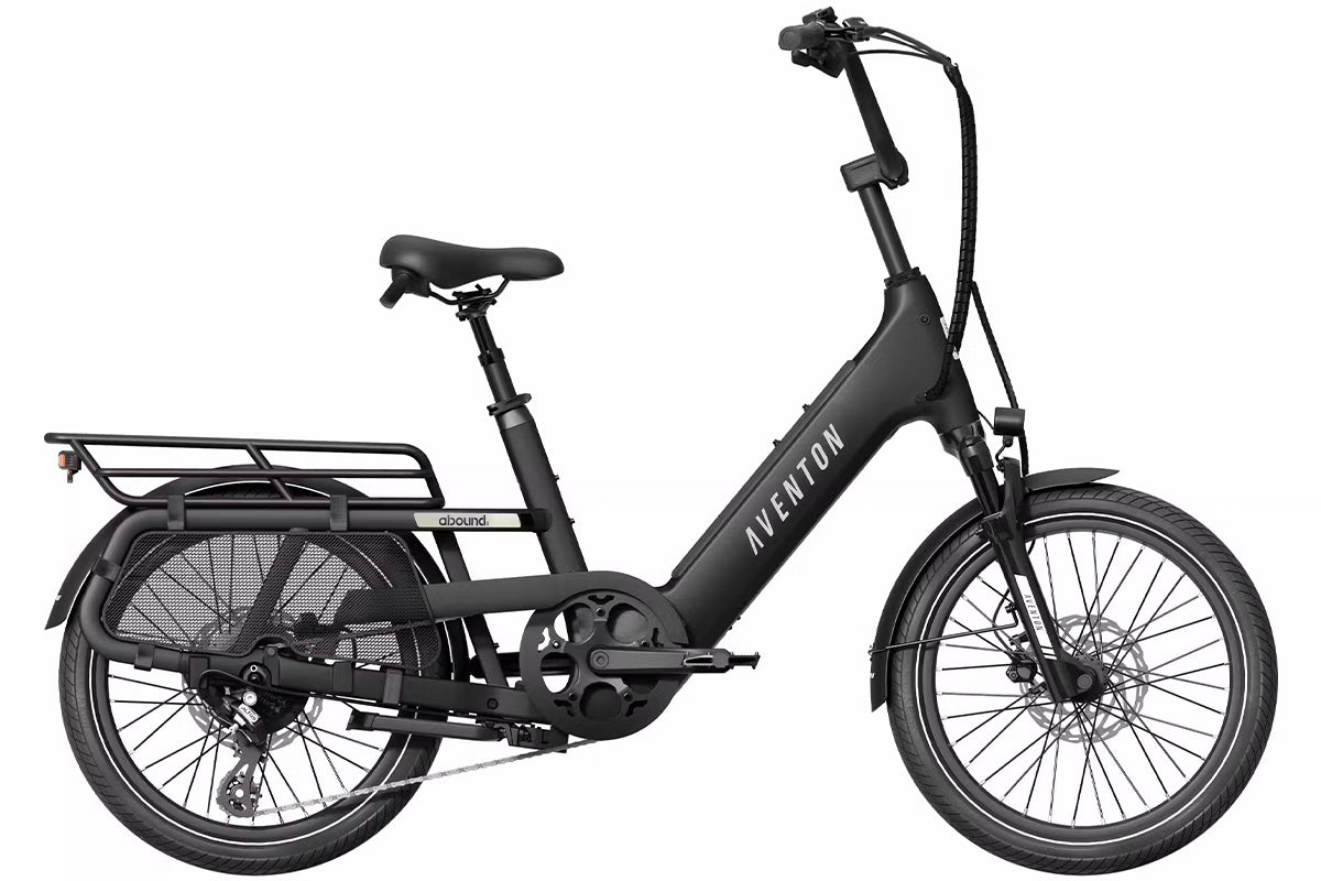 Aventon Abound SR cargo eBike parked next to a grocery basket.